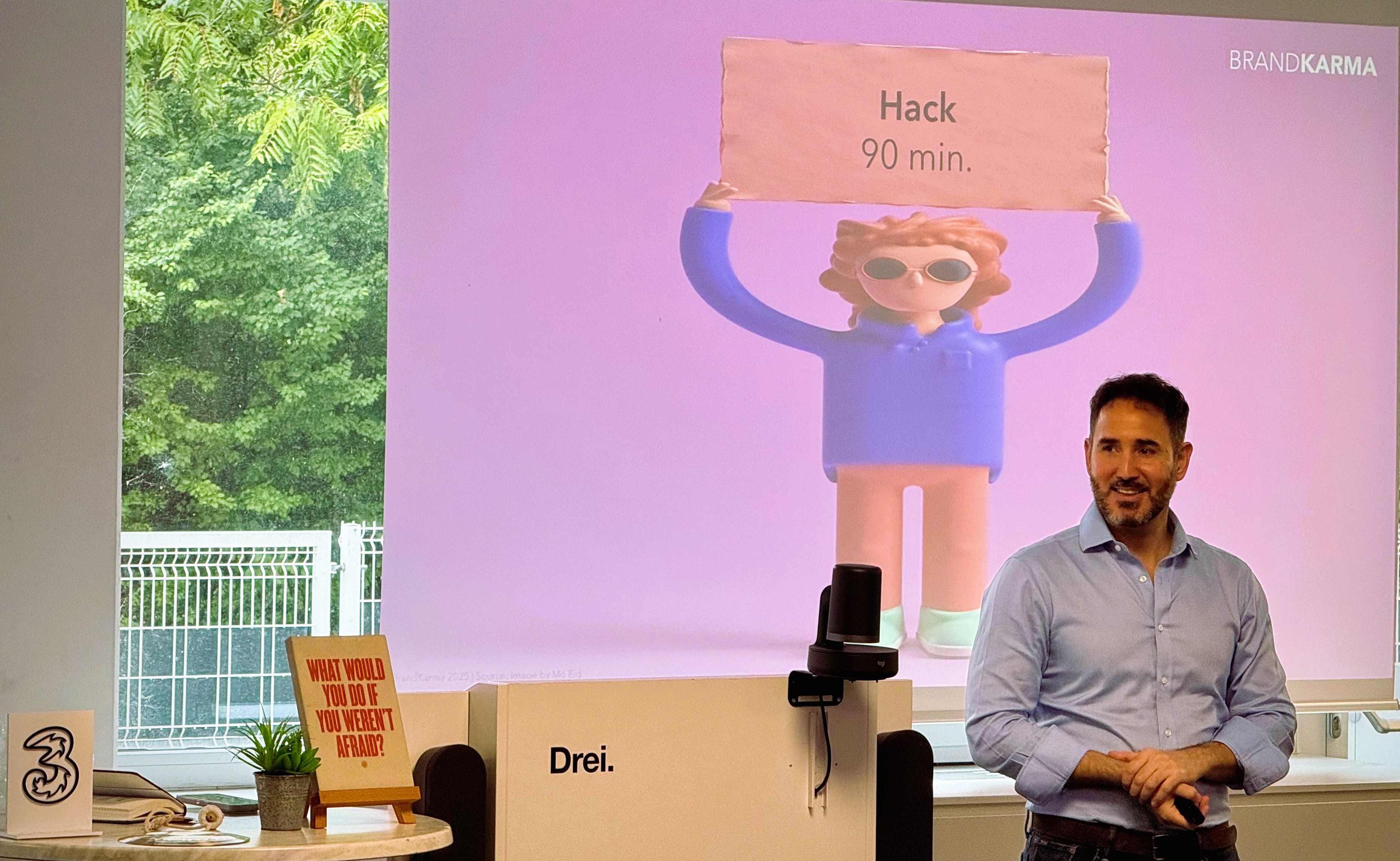 Eliot standing at the Drei office facilitating an AI hack.